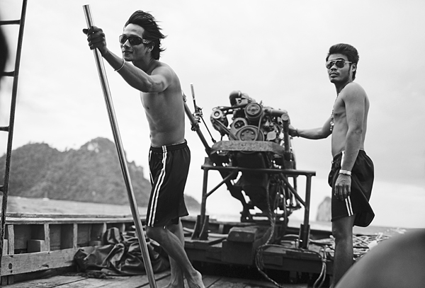 guys driving a long tail boat