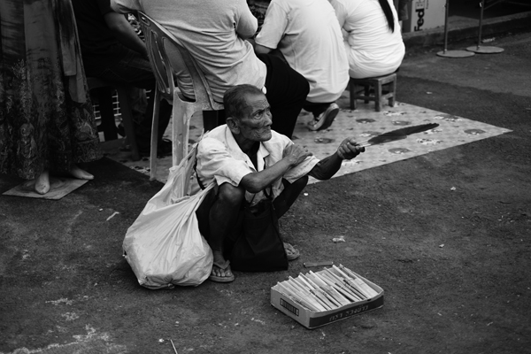 old man selling fan