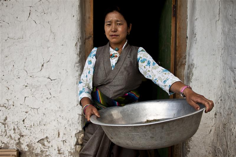 A local woman performing her daily duties in one of the households in Upper Mustang