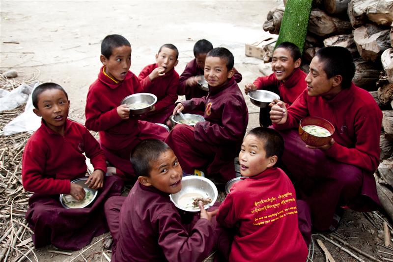 Monks eat together outside the monastery and enjoy their time.