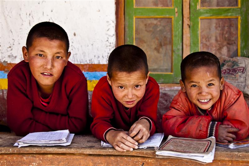 Three monks in the monastic school enjoy a moment in Upper Mustang