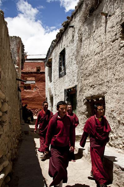 Young monks come out of the monastery for a break after prayers in Lo Mantang