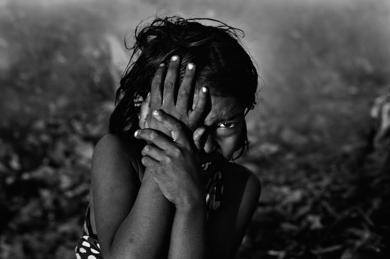 A girl gets injured from an explosion while collecting garbage