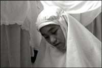 A girl during her midday prayer at an orphanage in Banda Aceh Indonesia