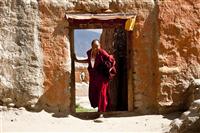 A monk in picture posing as he arrives from the village back to the monastery in Tsarang