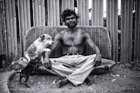 Billy’ Stuart Ah Choo sitting outside his home in Kennedy Hill with his beloved dog