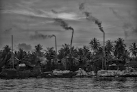 Smoke billows from one of the many factories that repurpose coconut husks