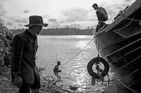 Workers prepare to attempt to salavage a piece of submerged lumber